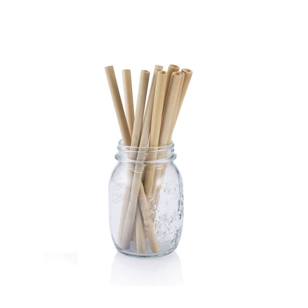 A glass jar with bamboo straws in it