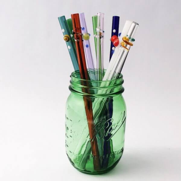 Glass straws in a green glass jar